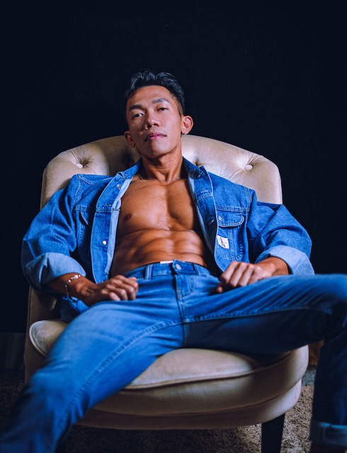 Man in blue suit seated in chair