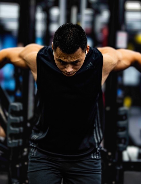 Man training in black tank top
