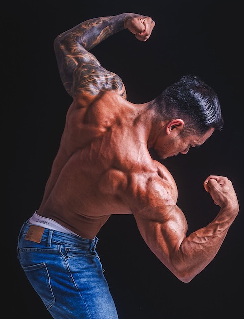 Tattooed man flexing